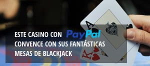 Una mano sostiene dos cartas. En un recuadro en la parte inferior se anuncia que en el casino se puede pagar con PayPal.