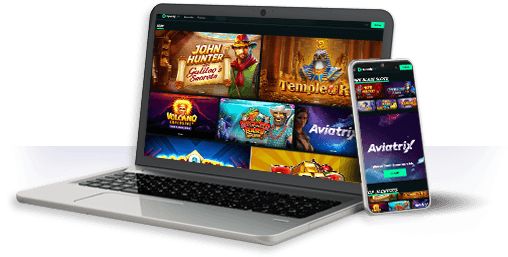 Un ordenador y un móvil con la oferta de juegos de SpeedyBet